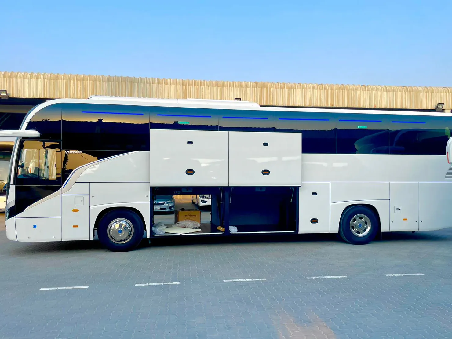 BusCom coach with its luggage bays open, for group transfers in Porto